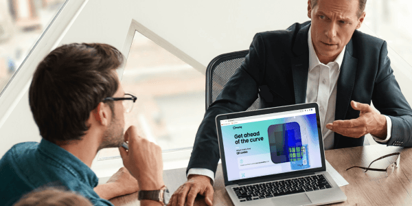 Photo showing two businessmen and a laptop with the polytag website