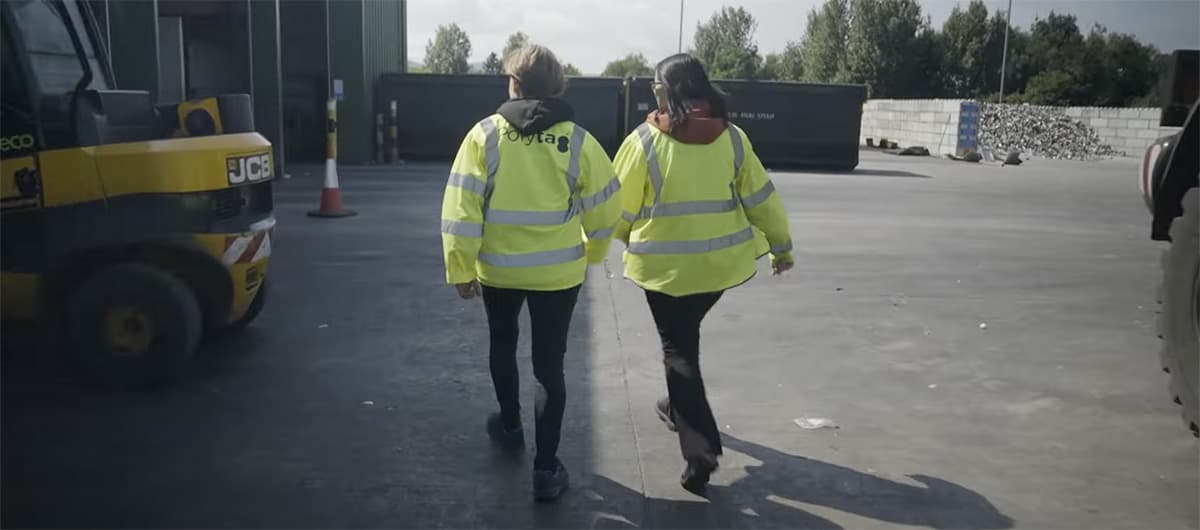 Photo of two people in high vis jackets