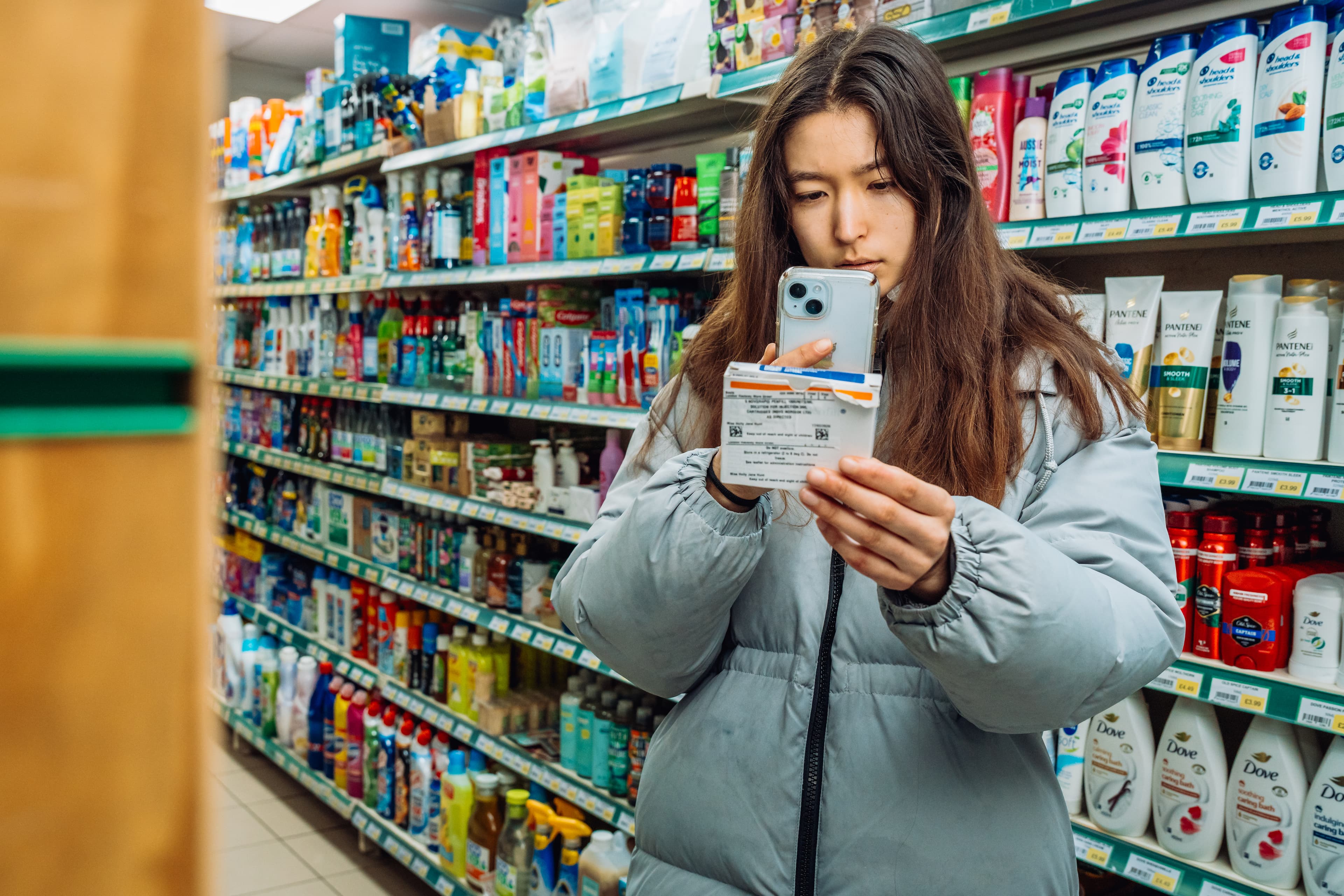 A shopper scanning the Smart QR Code on a pack in a store aisle