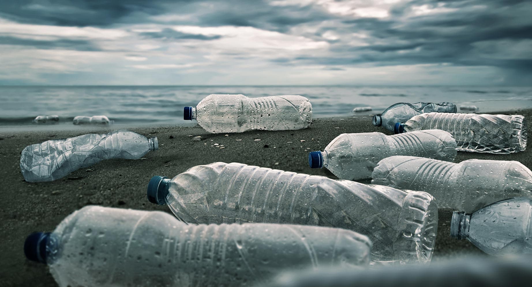 Photo of plastic bottle packaging discarded on a beach