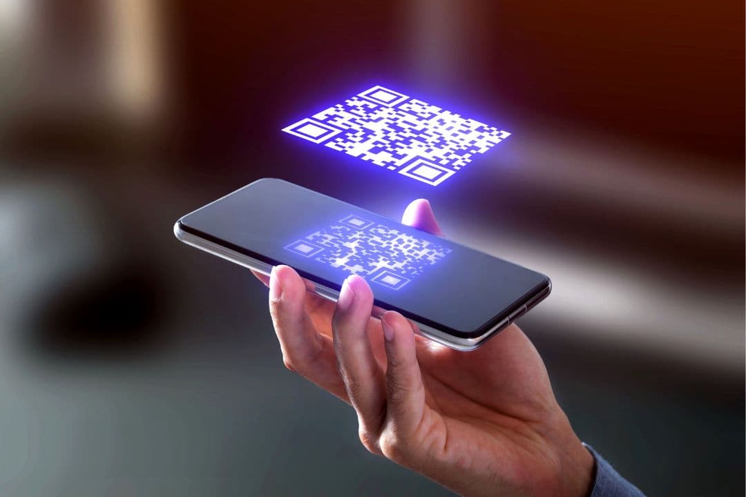 Photo of a smartphone with a virtual QR code graphic hovering above the screen