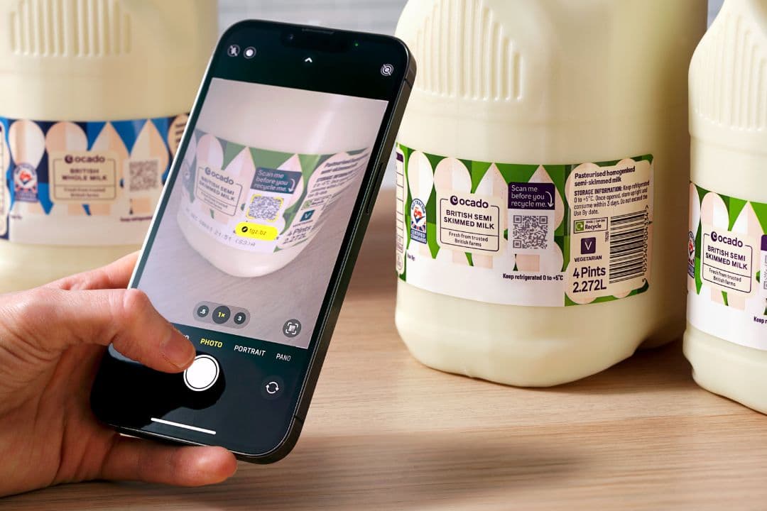 Photo of a smartphone scanning a QR code on milk packaging